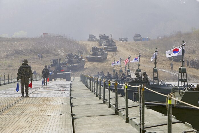 Crossing over a floating bridge April 8, Soldiers drive 68-ton M1A2 Abrams Main Battle Tanks and 27-ton M2A3 Bradley Infantry Fighting Vehicles, across the Imjin River. Soldiers from the 2nd Battalion, 8th Cavalry Regiment, 1st Armored Brigade Combat Team, 1st Cavalry Division, crossed the bridge assembled by the Republic of Korea Army 6th Engineer Brigade as part of a four-day, combined arms river crossing exercise.