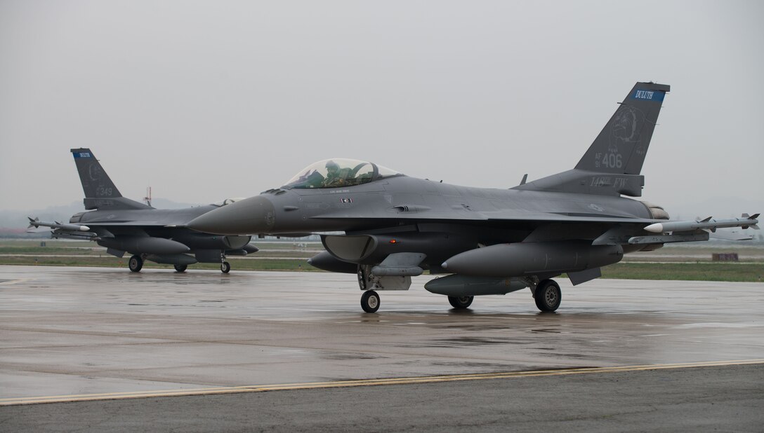 F-16 Fighting Falcons from the 148th Fighter Wing taxi on the flightline after arriving to Osan Air Base, Republic of Korea, April 20, 2016. The 148th FW out of Duluth Air National Guard Base, Minnesota, deployed 12 F-16 aircraft to Osan as part of a theater security package to enhance regional security on the Korea Peninsula. The U.S. Air Force routinely deploys force packages of fighters throughout the Republic of Korea to demonstrate the U.S. commitment to stability on the Korea Peninsula. (U.S. Air Force photo by Senior Airman Dillian Bamman/Released)
