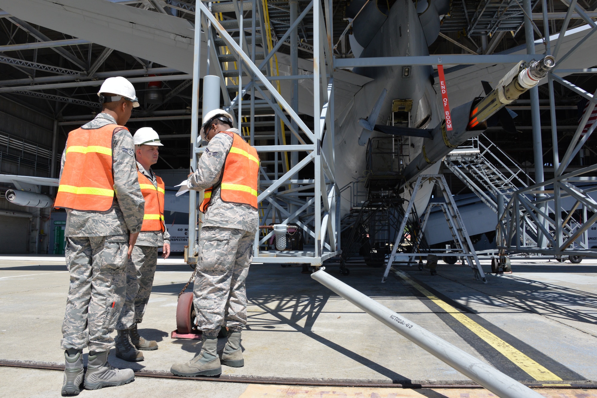 A three-man team perform inspections as part of the Phoenix Pride Program April 18 at Travis Air Force Base, Calif. Airman 1st Class Jamal White, aero repair technician, left, Staff Sgt. Adam Hite, metals technology craftsman, center, and Airman 1st Class Eric Lambert, section team member, right, from the 60th Maintenance Squadron, work together to use their individual expertise to uncover items that need correcting throughout the 18 different work centers. (U.S. Air Force photo by Senior Airman Amber Carter)