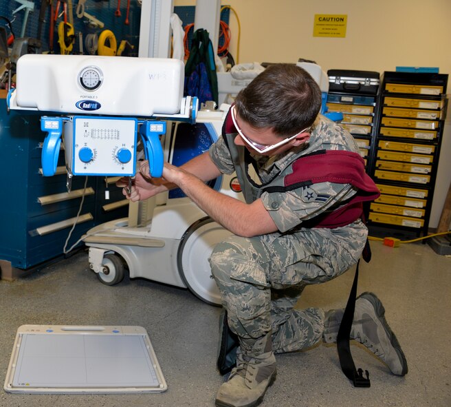 Airman 1st Class Ryan Sarkesian, 60th MDSS biomedical equipment technician, repairs a mobile radiographic unit April 20 at Travis Air Force Base, California. Sarkesian and his team are responsible for the medical equipment repairs and calibrations for David Grant USAF Medical Center which includes equipment that breaks and scheduled maintenance. (U.S. Air Force photo by Senior Airman Amber Carter)