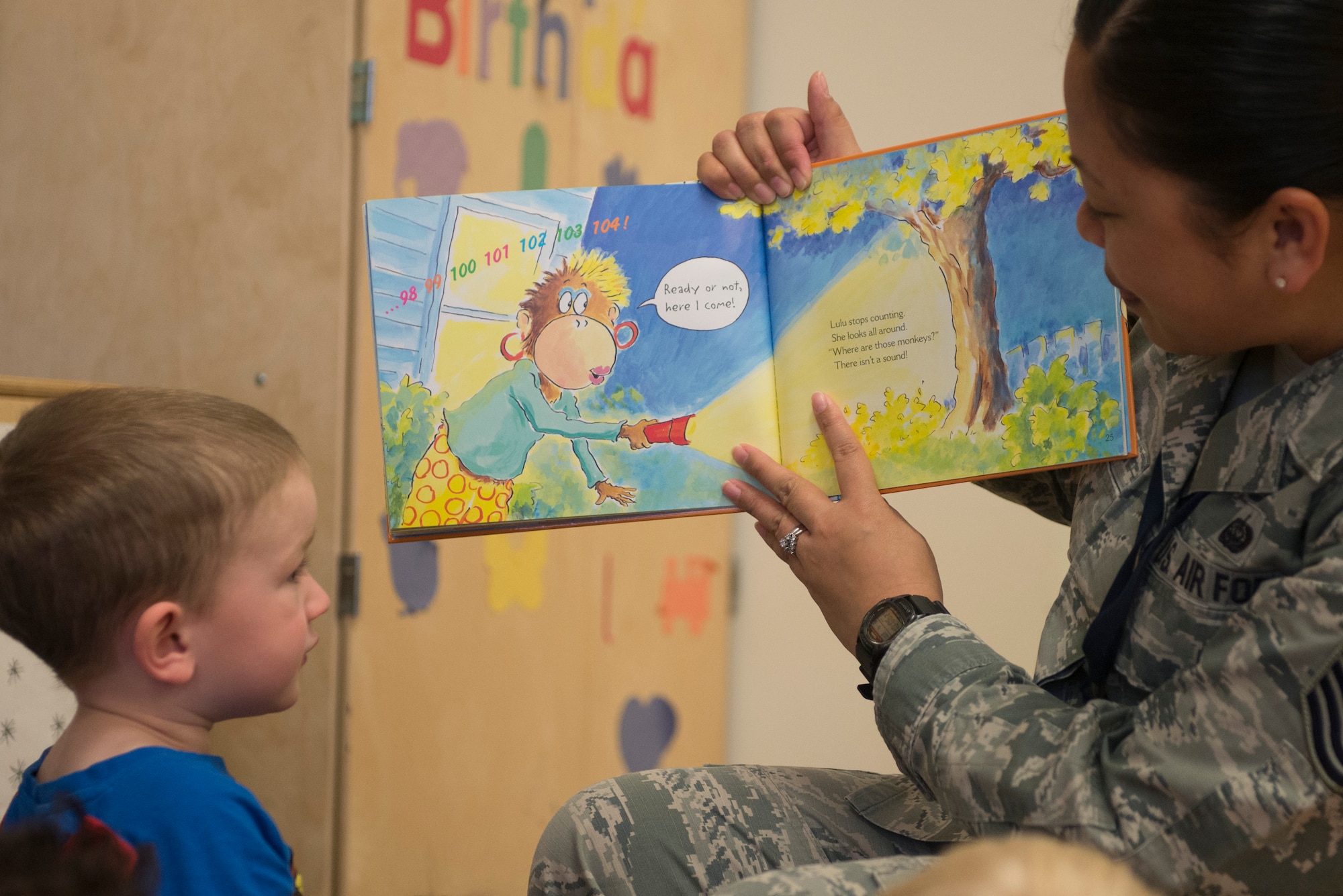 Master Sgt. Christina Kilburn, 618th Air Operations Center, begins to read Five Little Monkeys to the children at the Child Development Center April 6, 2016 at Scott Air Force Base, Illinois. Reading to children is a part of a volunteer program, Children and Airmen Reading Together, established by Scott's NCO Council. Once a month these volunteers read two to three books, which are picked by the children in each classroom.  (U.S. Air Force photo/Senior Airman Kiana Brothers)