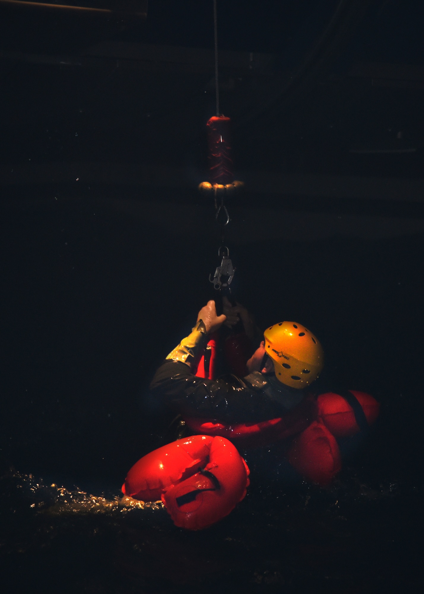 Cody Kelly, NASA engineer, holds on as he is hoisted up during a water survival training exercise April 19, 2016, at Fairchild Air Force Base, Wash. Five team members from NASA visited Fairchild to attend the Survival, Evasion, Resistance and Escape Water Survival Course. (U.S. Air Force photo/Airman 1st Class Taylor Bourgeous)