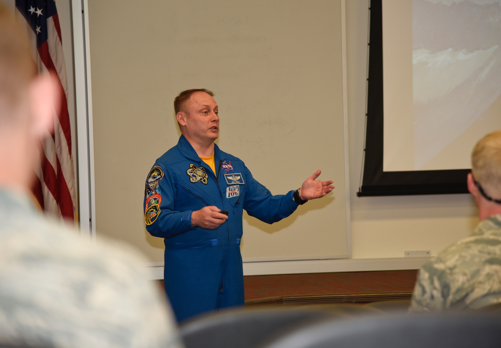 Col. Michael Fincke, NASA astronaut, speaks to Airmen during an all-call April 20, 2016, at Fairchild Air Force Base, Wash. Five team members from NASA visited Fairchild to attend the Survival, Evasion, Resistance and Escape Water Survival Course. “Right now we are here to evaluate the possibility of sending more astronauts here in the future,” Fincke said. (U.S. Air Force photo/Airman 1st Class Taylor Bourgeous)