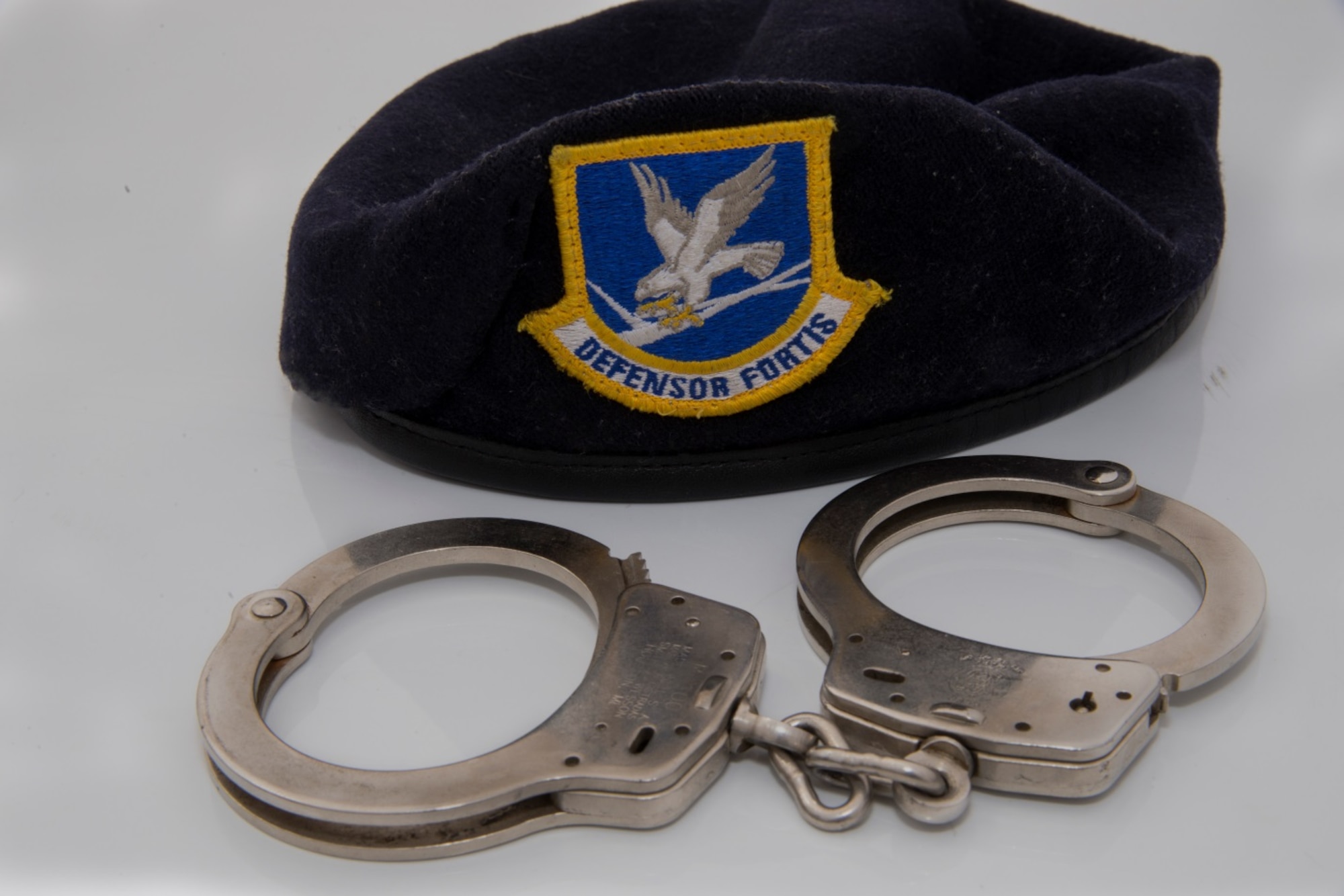 A pair of handcuffs and a security forces beret sits on a patrol car at Minot Air Force Base, N.D., April 14, 2016. Patrolling the base is one of several jobs the 5th Security Forces Squadron holds while keeping Minot’s personnel and assets safe. (U.S. Air Force photo/Airman 1st Class Christian Sullivan)