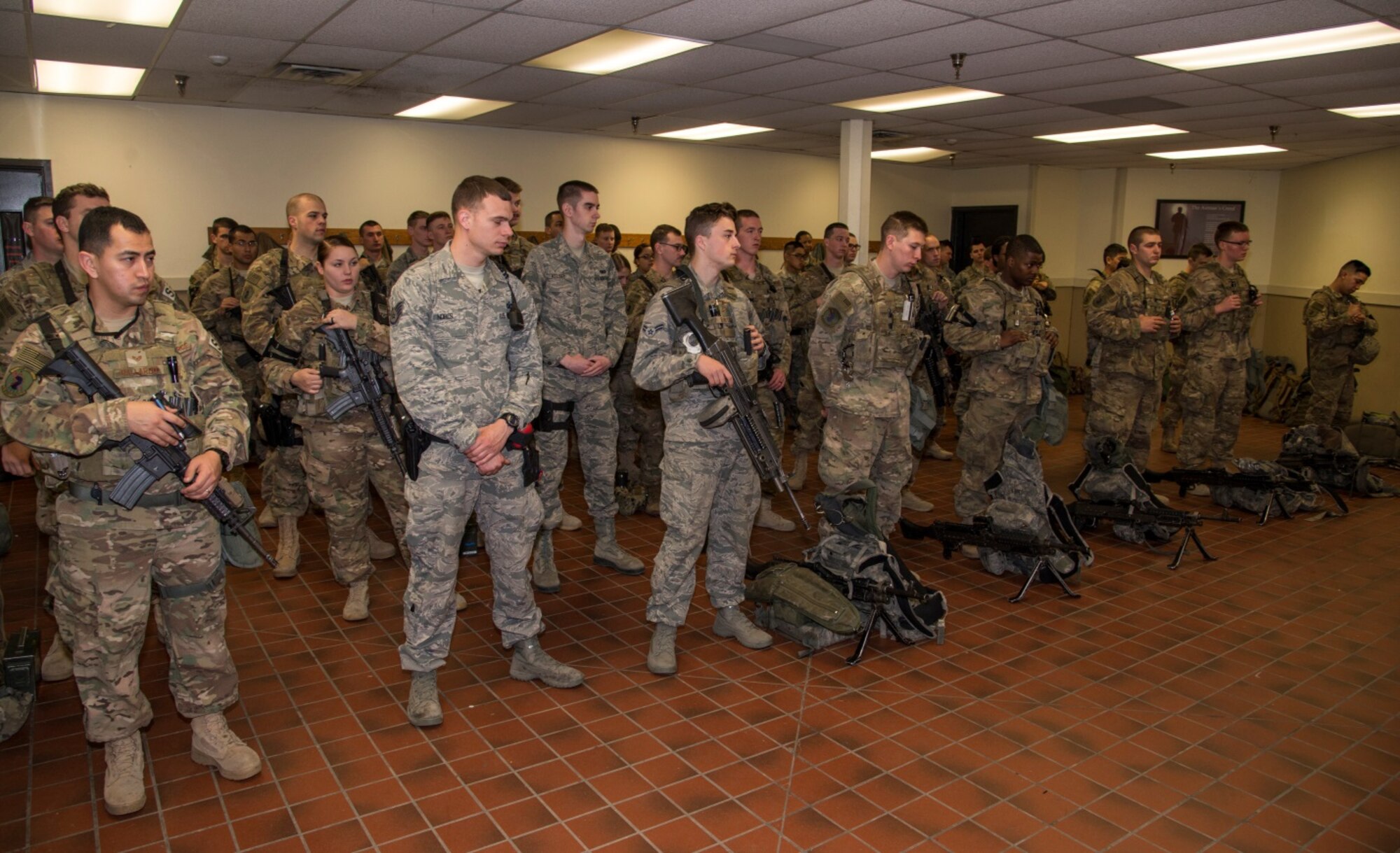 Security Forces  members listen to their daily guard mount briefing before the day begins at Minot Air Force Base, N.D., April 14, 2016. Security Forces members go through guard mount every day before they go about their normal mission so their leadership can brief them on what they need to know. (U.S. Air Force photo/Airman 1st Class Christian Sullivan)