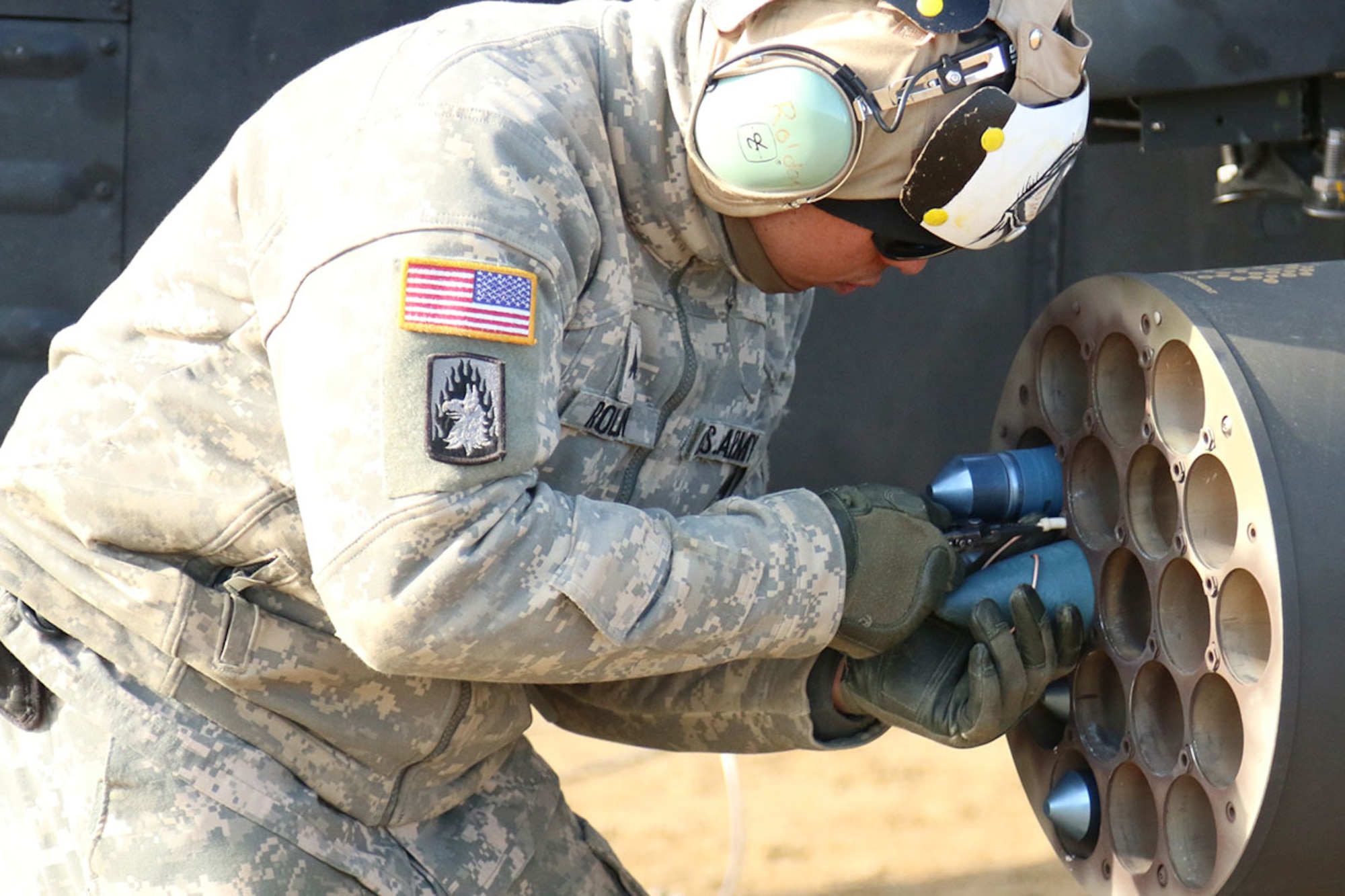 Sgt. Franzwillie Roldan, an AH-64D Armament/Electrical/Avionics Systems Repairer in 1st Attack Reconnaissance Battalion, 25th Combat Aviation Brigade places a training missile into an Apache wing rocket missile pod April 4, 2016 at the Forward Area Rearming Point at Yukon Training Area. (U.S. Army photo/Spc. Samantha L. Magers)