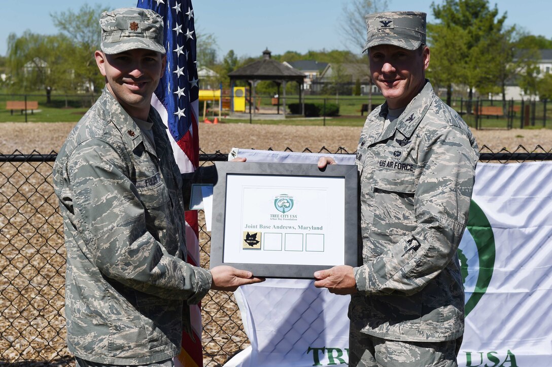 Col. Bradley Hoagland, Joint Base Andrews and 11th Wing commander, and Maj. Michael Fuller, 11th Civil Engineering Squadron operations chief, received the Tree City Award from the National Arbor Day Foundation at a tree planting ceremony in honor of Earth Day and Arbor Day at Joint Base Andrews, Md., April 20, 2016. JBA received its 16th award from the foundation and celebrated the 40th Anniversary of the Tree City Program. (U.S. Air Force photo by Senior Airman Joshua R. M. Dewberry/RELEASED)