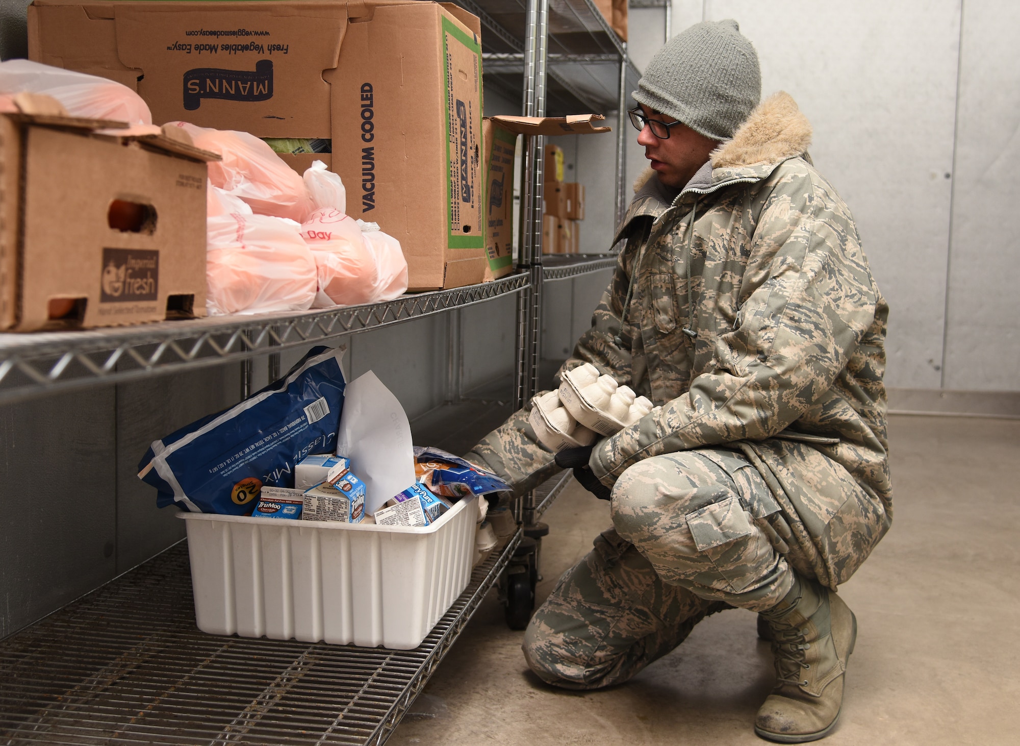 Senior Airman Garrison West, 341st Force Support Squadron accountant and store room clerk, places items in a cooler to be sent out to missile chefs posted at missile alert facilities April 20, 2016, at Malmstrom Air Force Base, Mont. Orders are brought to the site by missile alert crews traveling out that morning, and in the evening the returning crews bring back the coolers to be used for the next day. (U.S. Air Force photo/Senior Airman Jaeda Tookes)