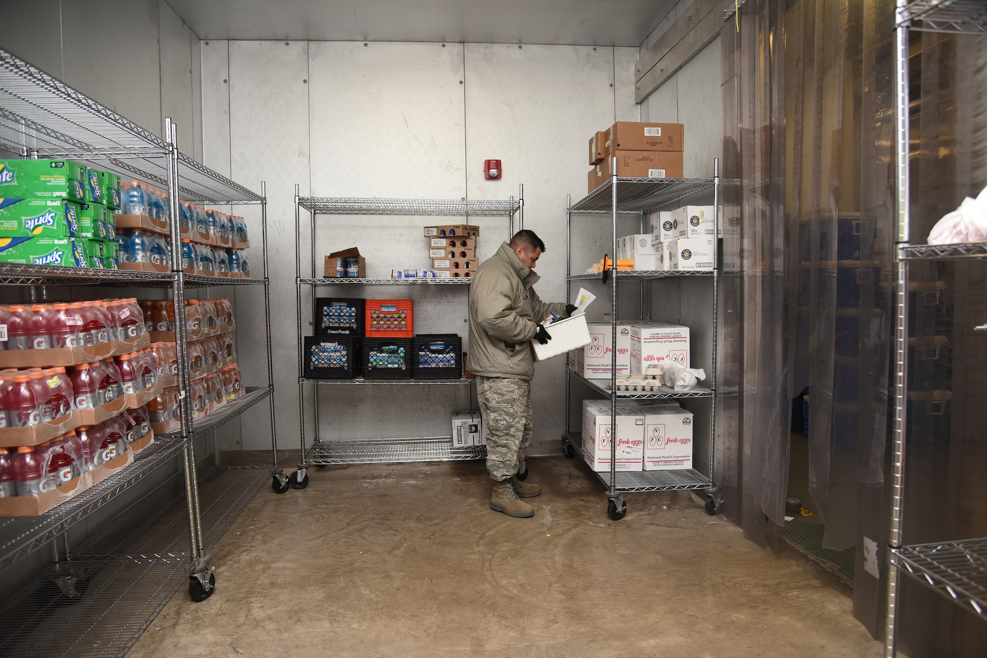 Tech. Sgt. Adam Aguilar, 341st Force Support Squadron NCO in charge of the central distribution section, fills incoming orders for missile chefs in a refrigerator April 20, 2016, at Malmstrom Air Force Base, Mont. Chefs send their orders to the CDS based on the previous day’s work at missile alert facilities. (U.S. Air Force photo/Senior Airman Jaeda Tookes)
