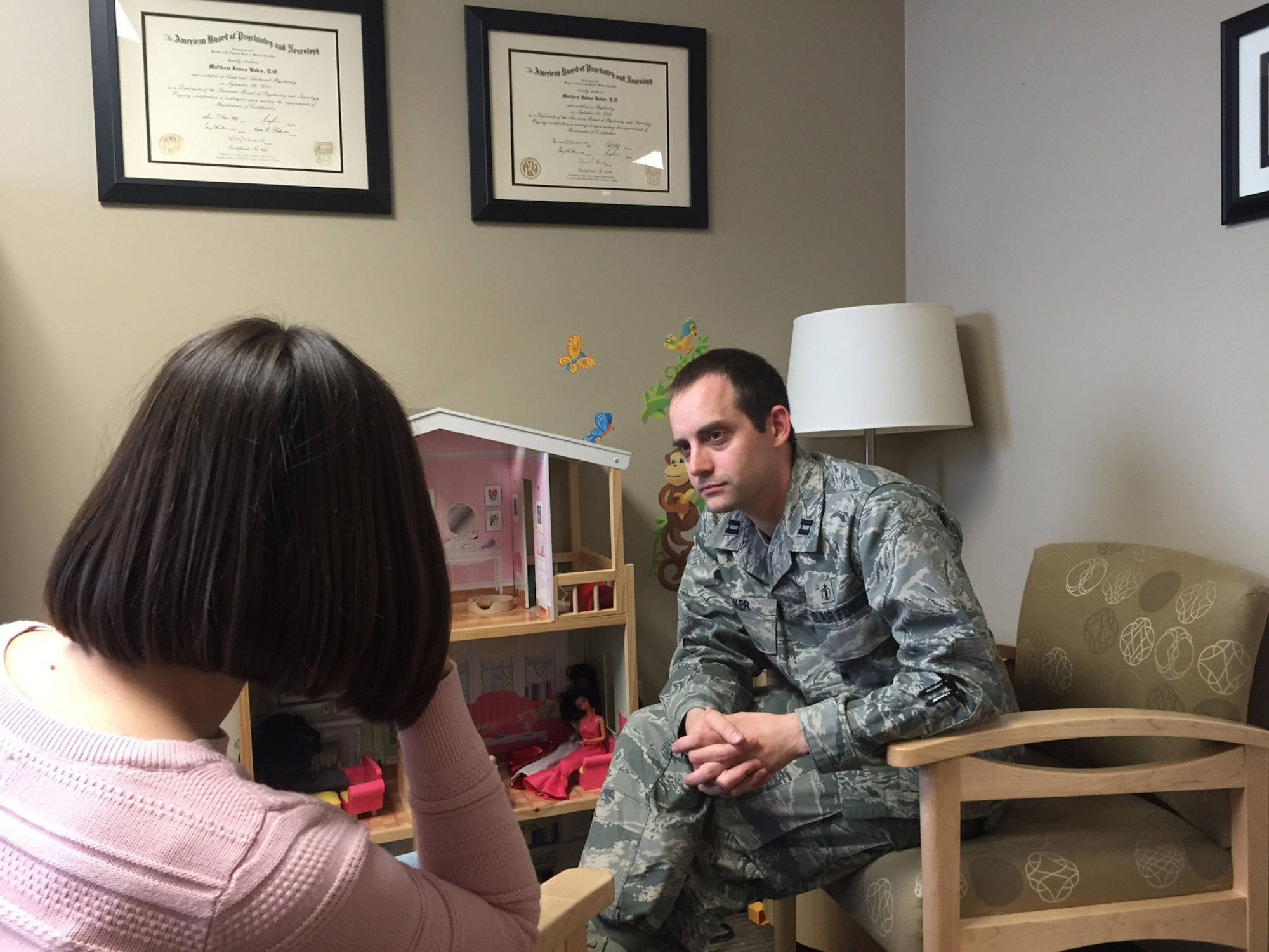 Dr. Matthew Baker, a psychiatrist assigned to the 88th Medical Operations Squadron, Wright-Patterson Air Force Base, Ohio, consults with a client. (U.S. Air Force courtesy photo)