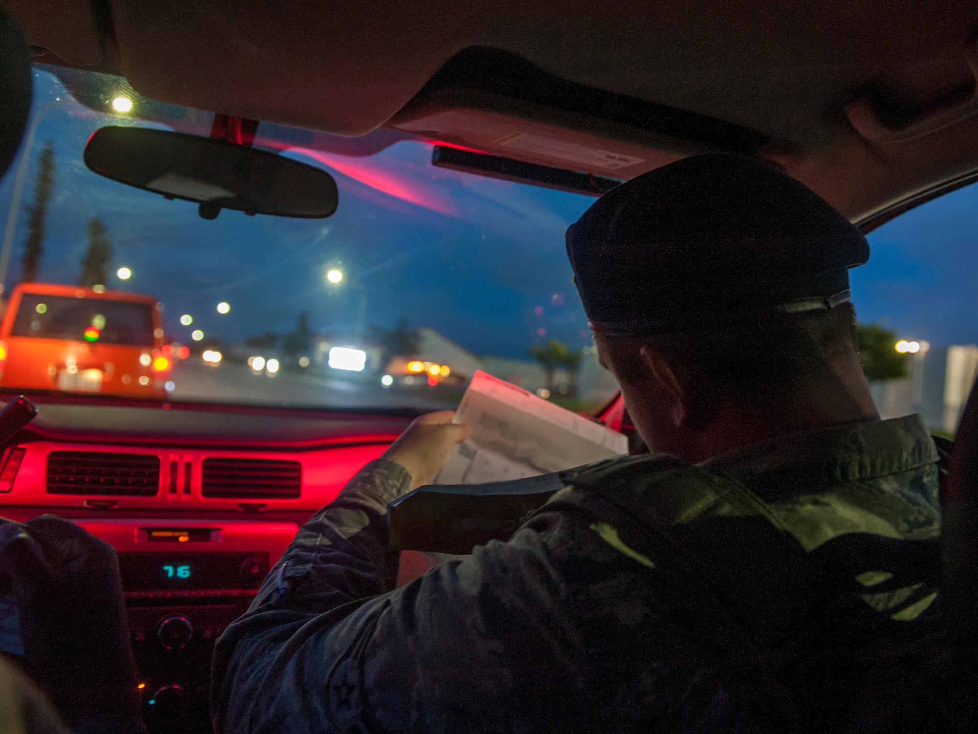 U.S. Air Force Airman 1st Class Ryan MacDonald, 18th Security Forces Squadron response force member, checks the JCI and registration paperwork during a traffic stop April 21, 2016, at Kadena Air Base, Japan. Traffic stops is a method SFS use to enforce traffic laws and code. (U.S. Air Force photo by Tech. Sgt. Darnell T. Cannady)