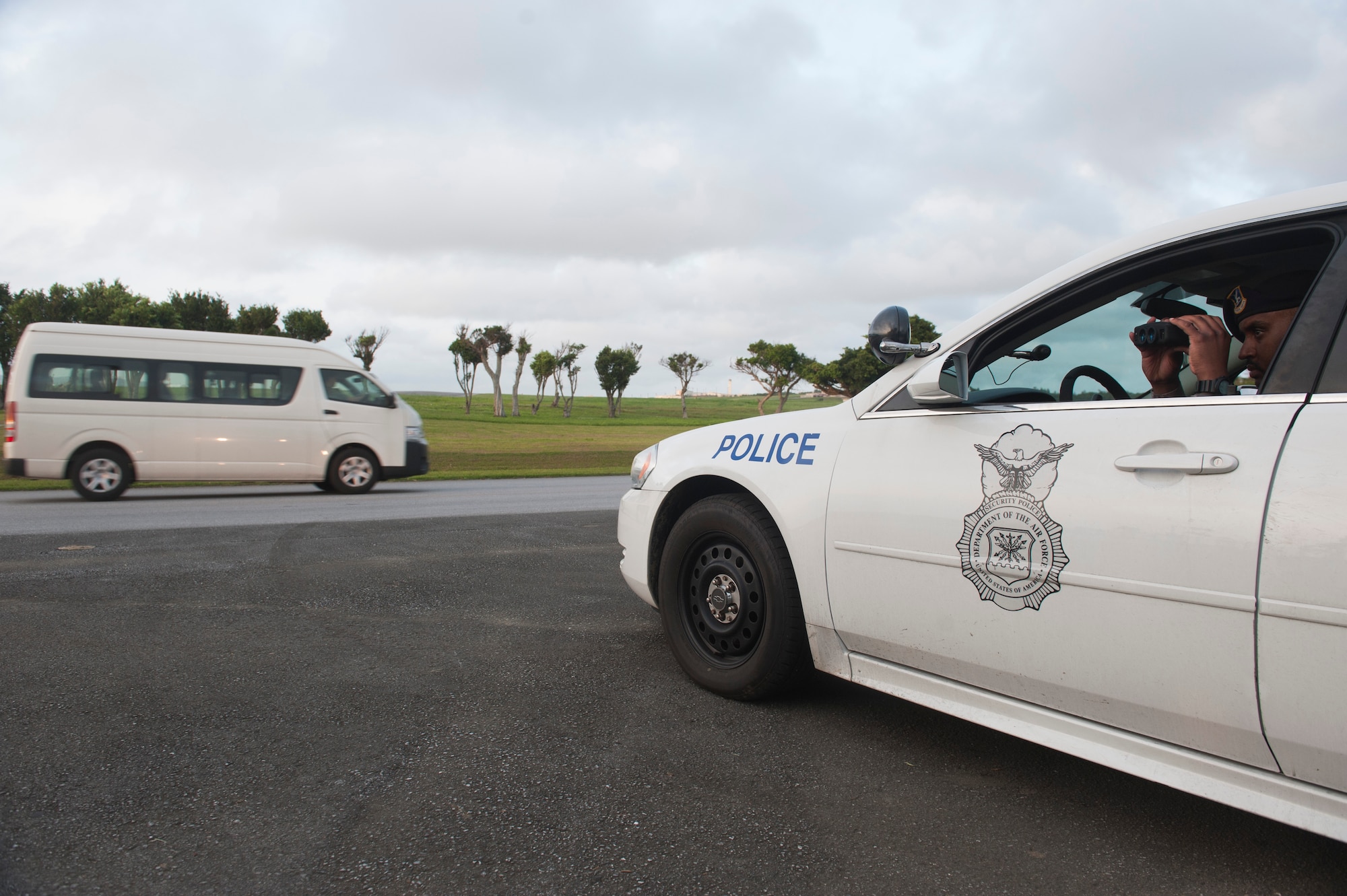 U.S. Air Force Tech. Sgt. Terrance McGee, 18th Security Forces Squadron assistant flight chief, uses a LiDAR speed gun to check traffic speed April 21, 2016, at Kadena Air Base, Japan. Monitoring traffic speed is vital to ensuring the safety and compliance of law to all members of Kadena. (U.S. Air Force photo by Tech. Sgt. Darnell T. Cannady)