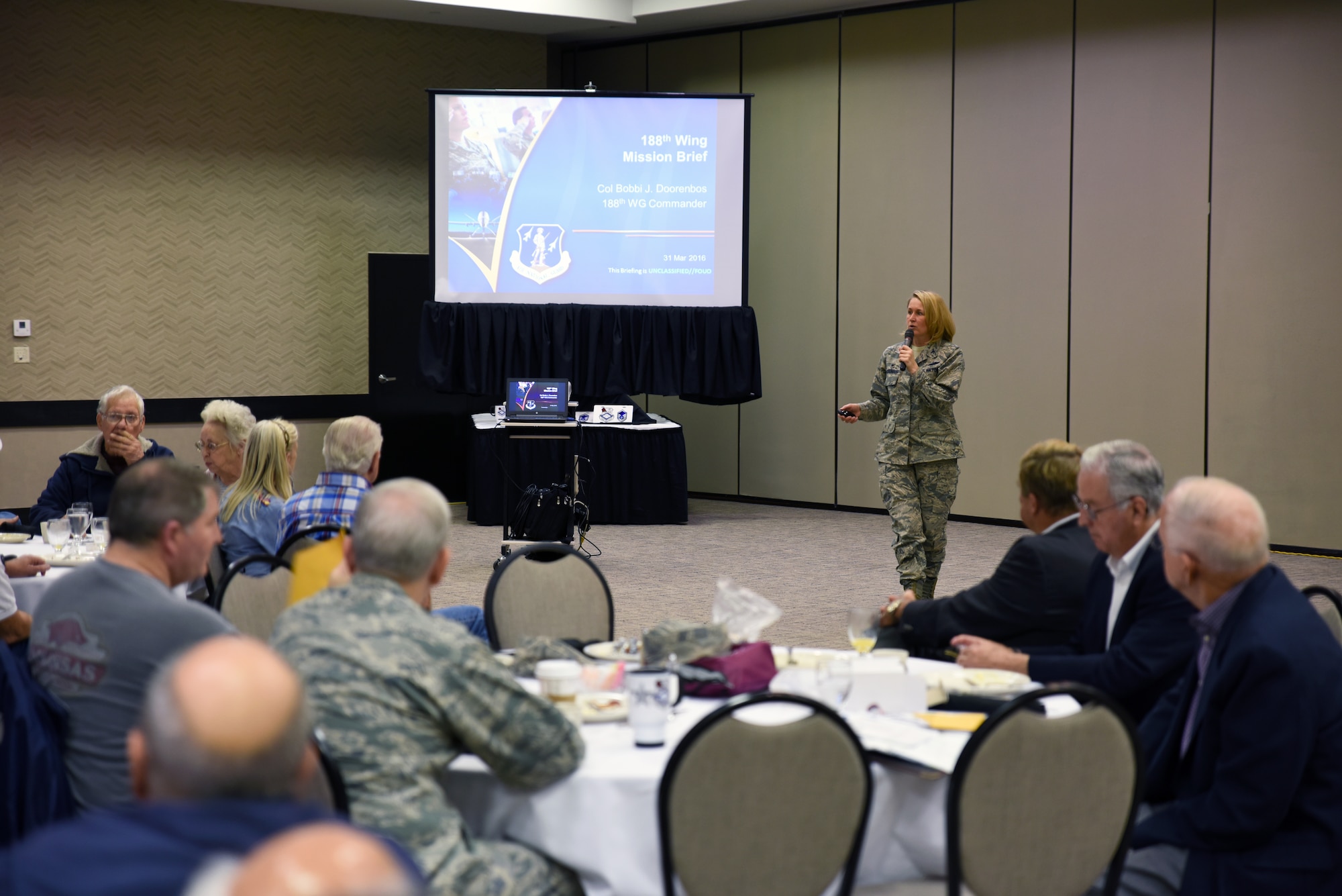 Col. Bobbi Doorenbos, 188th Wing commander, discusses the 188th’s mission to members of the 188th Old Guard, a group comprised of retired Airmen formally a part of the 188th Wing, March 31, 2016, during a breakfast held at the Executive Hotel at City Center in Fort Smith, Ark. The Old Guard showcased a new logo during the breakfast, which was developed to establish an identity and to have visual recognition. (U.S. Air National Guard photo by Senior Airman Cody Martin/Released)
