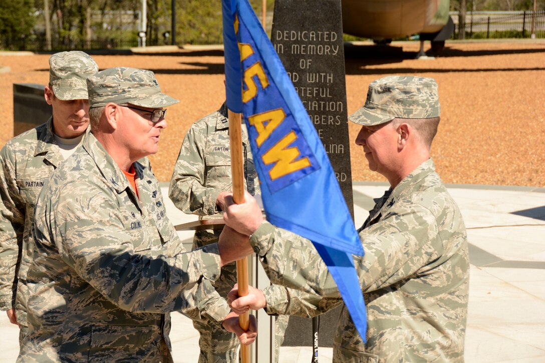 U.S. Air Force Col. Marshall C. Collins, commander of the 145th Airlift Wing, ceremoniously passes a guidon to Col. Russell L. Ponder, commander of the 145th Mission Support Group, during an assumption of command ceremony held at the North Carolina Air National Guard (NCANG) Base, Charlotte Douglas International Airport; April 9, 2016. The passing of the guidon is an Air Force tradition symbolizing the delegation of the commanding role and responsibility from one officer to another. Ponder, former commander of the 145th Civil Engineer Squadron, comes back to the NCANG after serving over five years at the Pentagon in the District of Columbia. (U.S. Air National Guard photo by Senior Airman Laura Montgomery/Released)