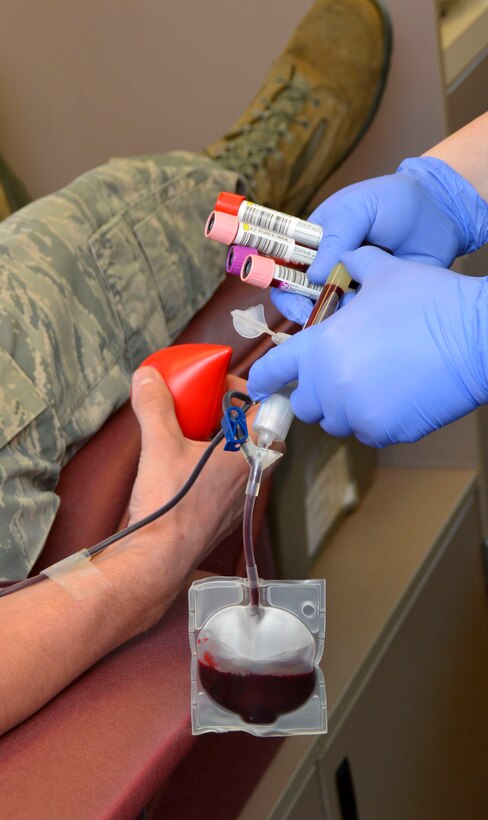 A U.S. Air Force Airman from the 145th Airlift Wing donates blood during a blood drive held at the North Carolina Air National Guard Base, Charlotte Douglas International Airport, April 9, 2016. The drive was sponsored by the Community Blood Center of the Carolinas. All blood donated goes to help patients who live in local communities. (U.S. Air National Guard photo by Master Sgt. Patricia F. Moran/Released)