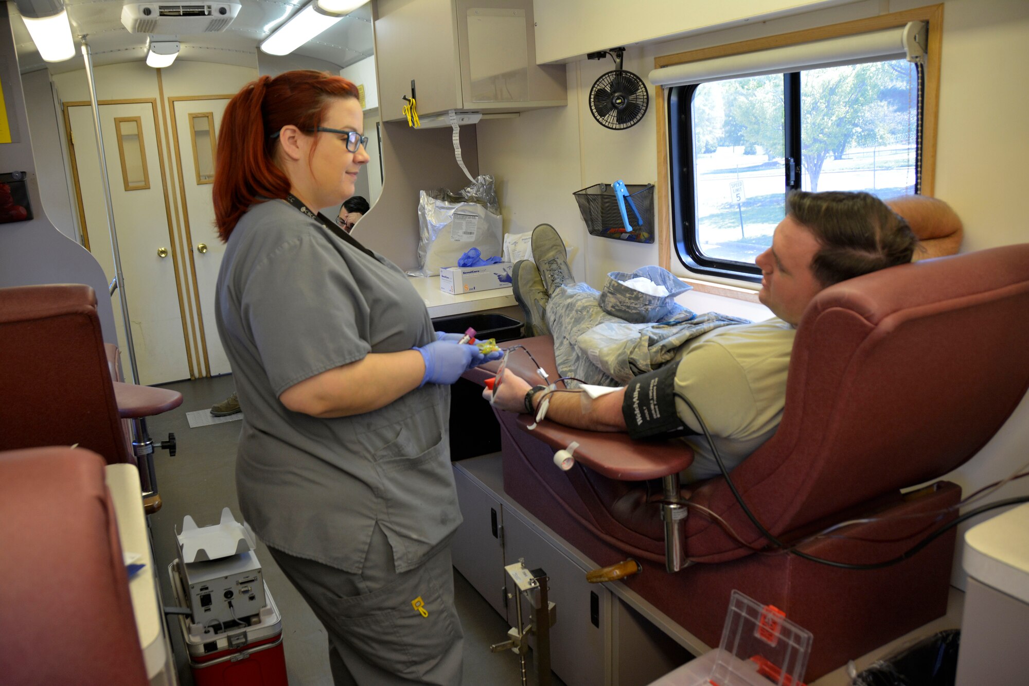 Ashley Gilbertson, mobile team leader for Community Blood Center of the Carolinas, (CBCC), draws blood from U.S. Air Force Staff Sgt. Matthew Partridge, medical technician with the 145th Medical Group, during a blood drive held at the North Carolina Air National Guard Base, Charlotte Douglas International Airport, April 9, 2016. All blood donated through CBCC goes to help patients in need, who live in the local community. Donating just one pint of blood takes less than an hour but can save up to three lives.  (U.S. Air National Guard photo by Master Sgt. Patricia F. Moran/Released)