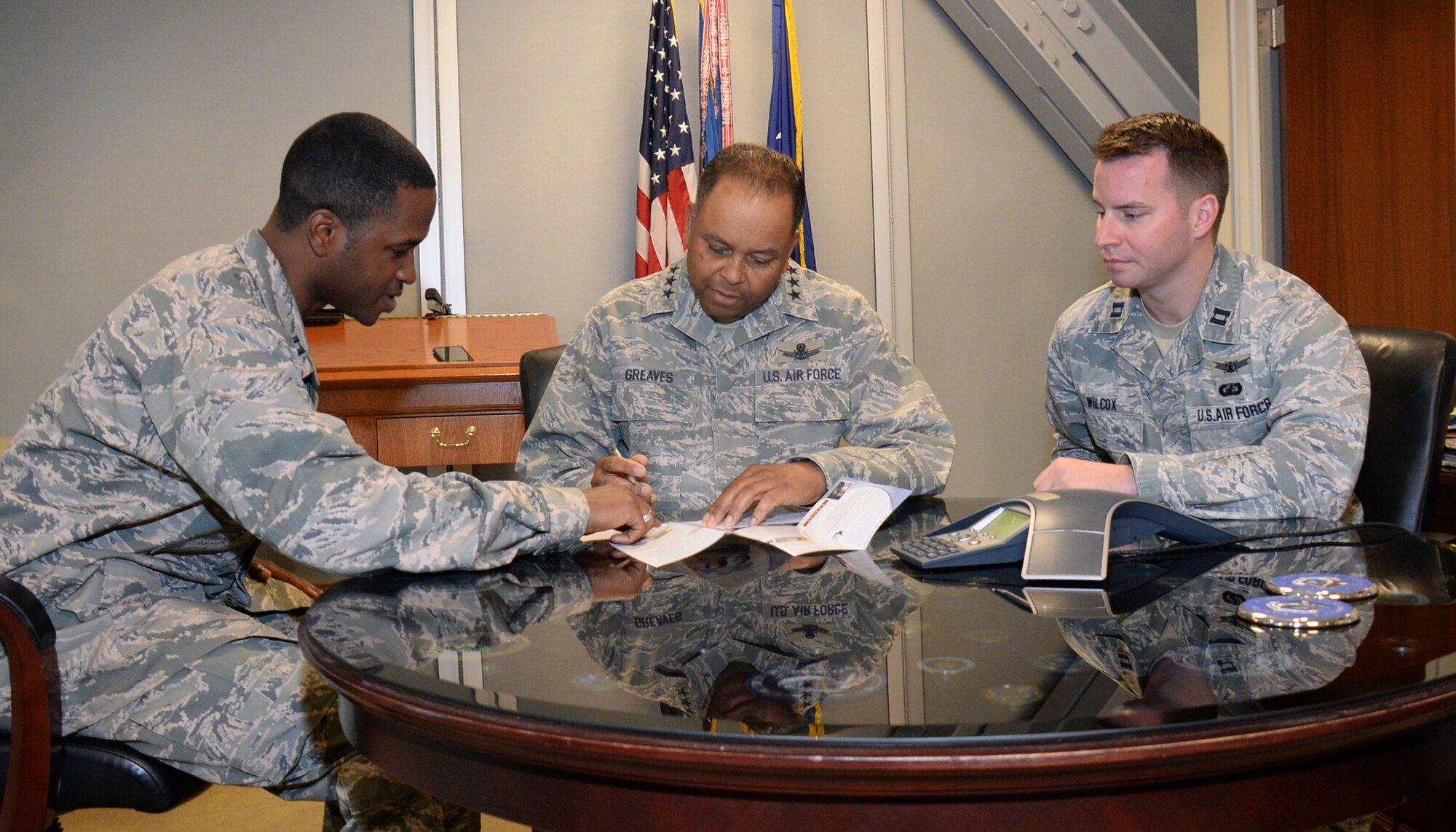 Lt. Gen. Samuel Greaves, Space and Missile Systems Center commander and Air Force program executive officer for space, signs his Air Force Assistance Fund pledge form as Capt. Rey Heron (left), SMC Financial Management cost analyst and AFAF project officer and Capt. Robert Wilcox, SMC Commander’s Action Group officer look on. Now in its 44th year, this year's AFAF campaign kicked off March 21 and runs through April 29. The annual fundraising drive benefits four official Air Force charities: the Air Force Aid Society, Air Force Village Foundation, Air Force Enlisted Village, and the General and Mrs. Curtis LeMay Foundation. (U.S. Air Force photo/Van De Ha)