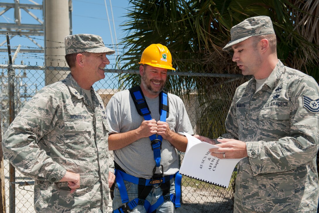 Brig. Gen. Wayne Monteith, 45th Space Wing commander, receives a confined space entry safety briefing before going into a manhole with the 45th Space Communications Squadron to assist with repairing and replacing a copper communication line April 18, 2016, at Patrick Air Force Base, Florida. The wing commander and command chief visit with 45th SW members each month in order to gain a better understanding of the jobs their Airmen do daily, address their questions and concerns and look for ways they can provide additional support. (U.S. Air Force photo by Benjamin Thacker/released)