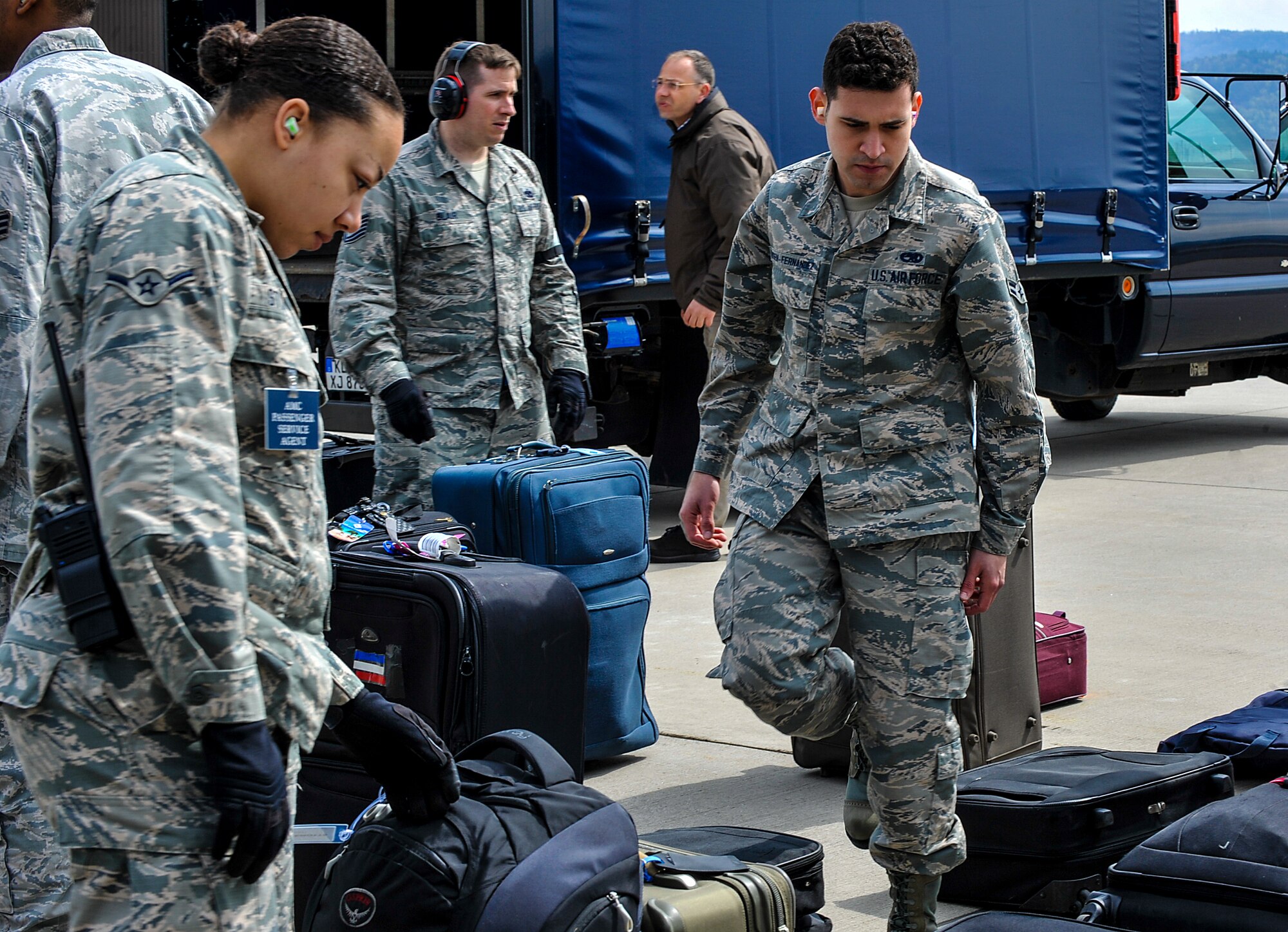 Airmen from the 721st Aerial Port Squadron sort passengers’ baggage April 17, 2016, at Ramstein Air Base, Germany. Airmen from different units came together to ensure the smooth arrival of military members, civilians and civic leaders. The passengers landed here and will have to opportunity to tour Ramstein to see how Airmen impact the Air Force mission. (U.S. Air Force photo/Senior Airman Larissa Greatwood)
