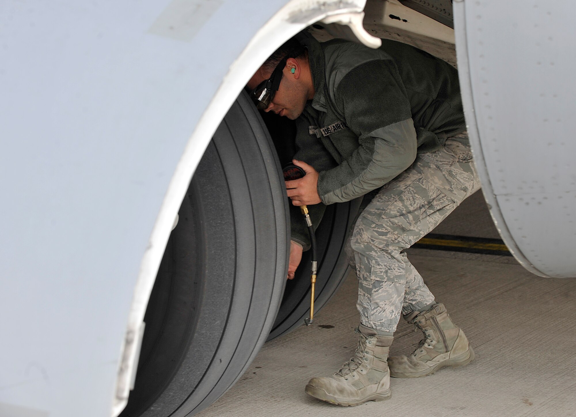 An Airman checks an aircraft’s tire pressure April 17, at Ramstein Air Base, Germany. Airmen from different units came together to ensure the smooth arrival of military members, civilians and civic leaders. The passengers landed here and will have to opportunity to tour Ramstein to see how Airmen impact the Air Force mission. (U.S. Air Force photo/Senior Airman Larissa Greatwood)