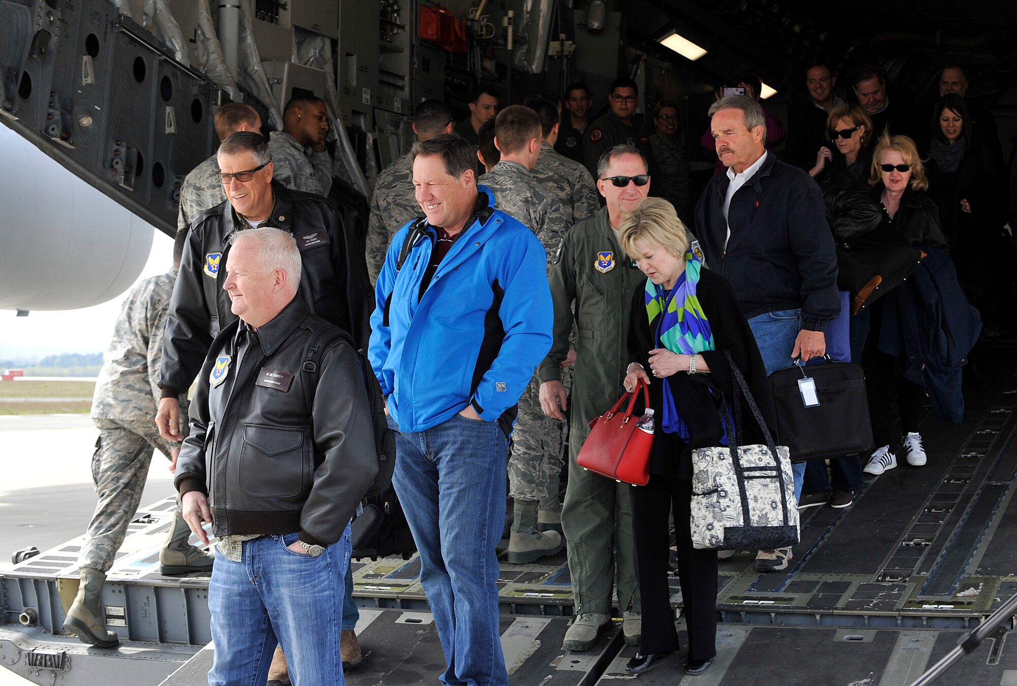 Passengers deplane and greet Ramstein leaders April 17, 2016, at Ramstein Air Base, Germany. The group is comprised of a variety of members from Guam to the continental U.S. with a variety of different backgrounds, with one common passion of service to Airmen and their families. (U.S. Air Force photo/Senior Airman Larissa Greatwood)