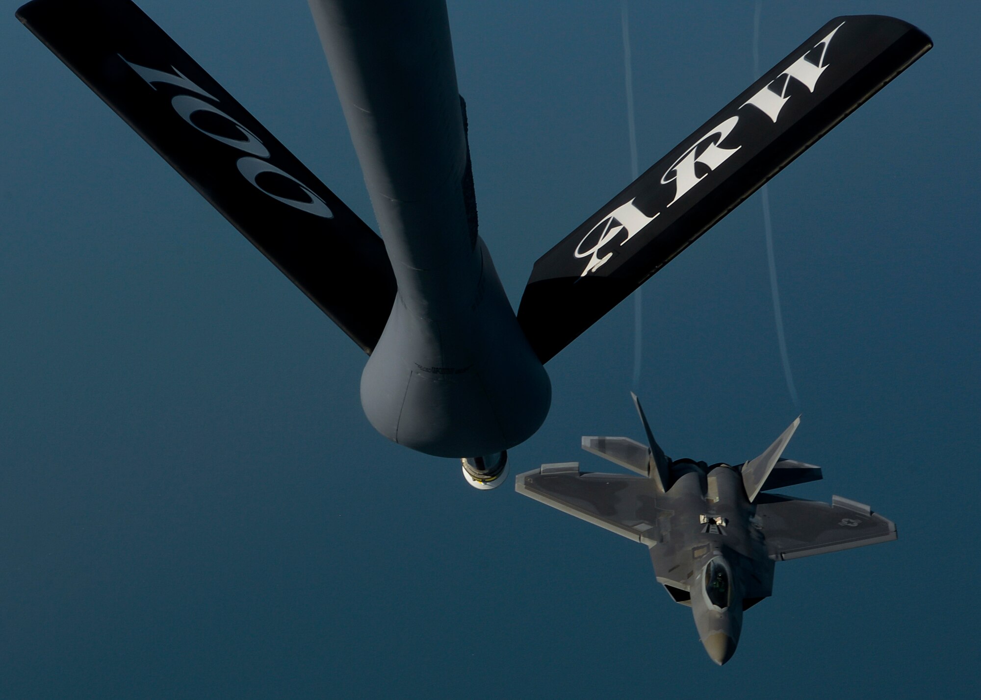 An F-22 Raptor assigned to the 95th Fighter Squadron at Tyndall Air Force Base, Fla., pulls into position to receive fuel from a 100th Air Refueling Wing KC-135 Stratotanker assigned to RAF Mildenhall, England April 19, 2016, over the Norfolk Sea. The 95th FS participated in air training drills alongside F-15s and other Europe-based aircraft in support of exercise Iron Hand. (U.S. Air Force photo by Senior Airman Victoria H. Taylor/Released)