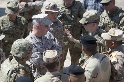 Marine Corps Gen. Joe Dunford, center left, chairman of the Joint Chiefs of Staff, speaks with Army Lt. Gen. Sean MacFarland, commander of Combined Joint Task Force Operation Inherent Resolve, at Besmaya Range Complex in Iraq, April 21, 2016. Dunford is visiting Iraq to assess the campaign against the Islamic State of Iraq and the Levant. DoD photo by Navy Petty Officer 2nd Class Dominique A. Pineiro