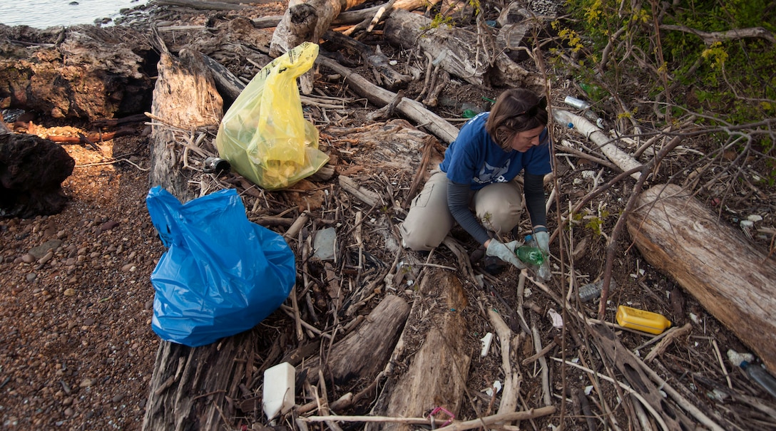 Michelle Kasunic, 11th Civil Engineer Squadron environmental engineer, picks up trash during a volunteer clean-up at Fort Washington, Md., April 16, 2016. Members from Joint Base Andrews joined with the local community to clean the Potomac River shore in commemoration of Earth Day. (U.S. Air Force photo by Airman Gabrielle Spalding/Released)
