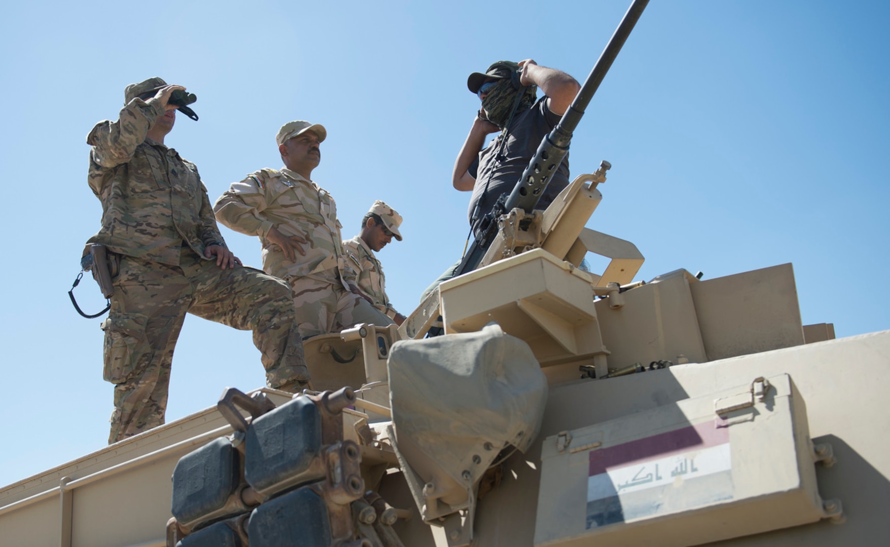 A U.S. soldier observes Iraqi soldiers during a live-fire exercise at Besmaya Range Complex in Iraq, April 21, 2016. Marine Corps Gen. Joe Dunford, chairman of the Joint Chiefs of Staff, met with Iraqi leaders and coalition trainers at the range. (DoD photo by Navy Petty Officer 2nd Class Dominique A. Pineiro)