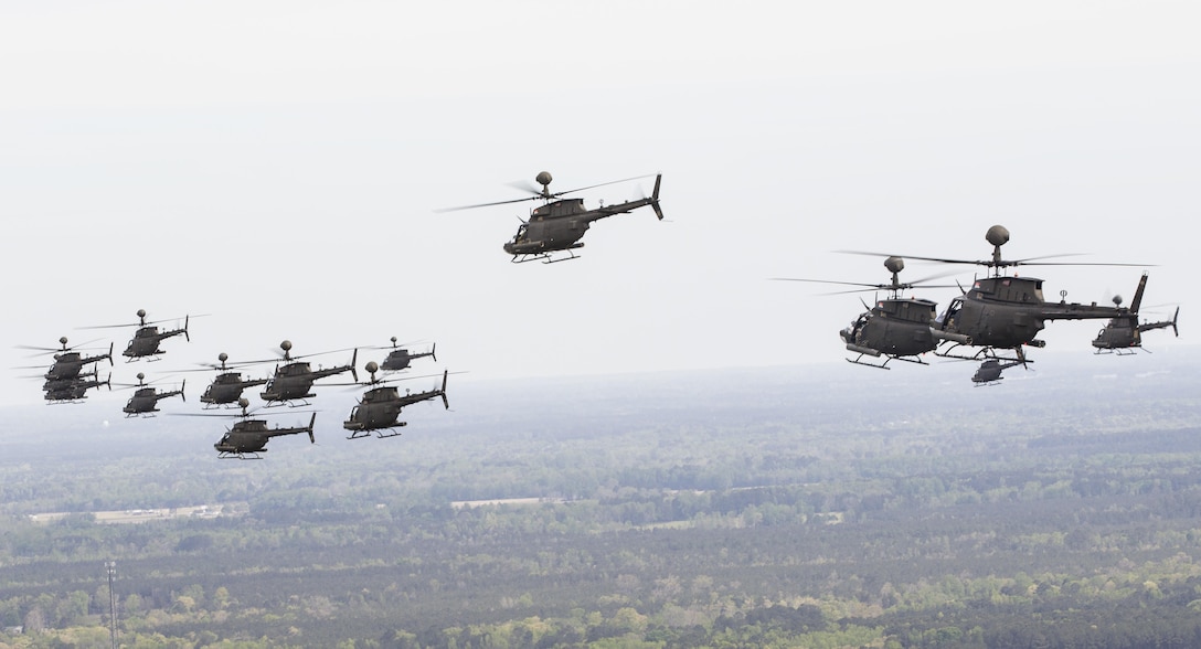 Thirty-two OH-58D Kiowa Warrior helicopters participate in a flyover above Fort Bragg, N.C., 2016, during the final stateside flight of the aircraft, April 15, 2016. Army photo by Sgt. Daniel Schroeder