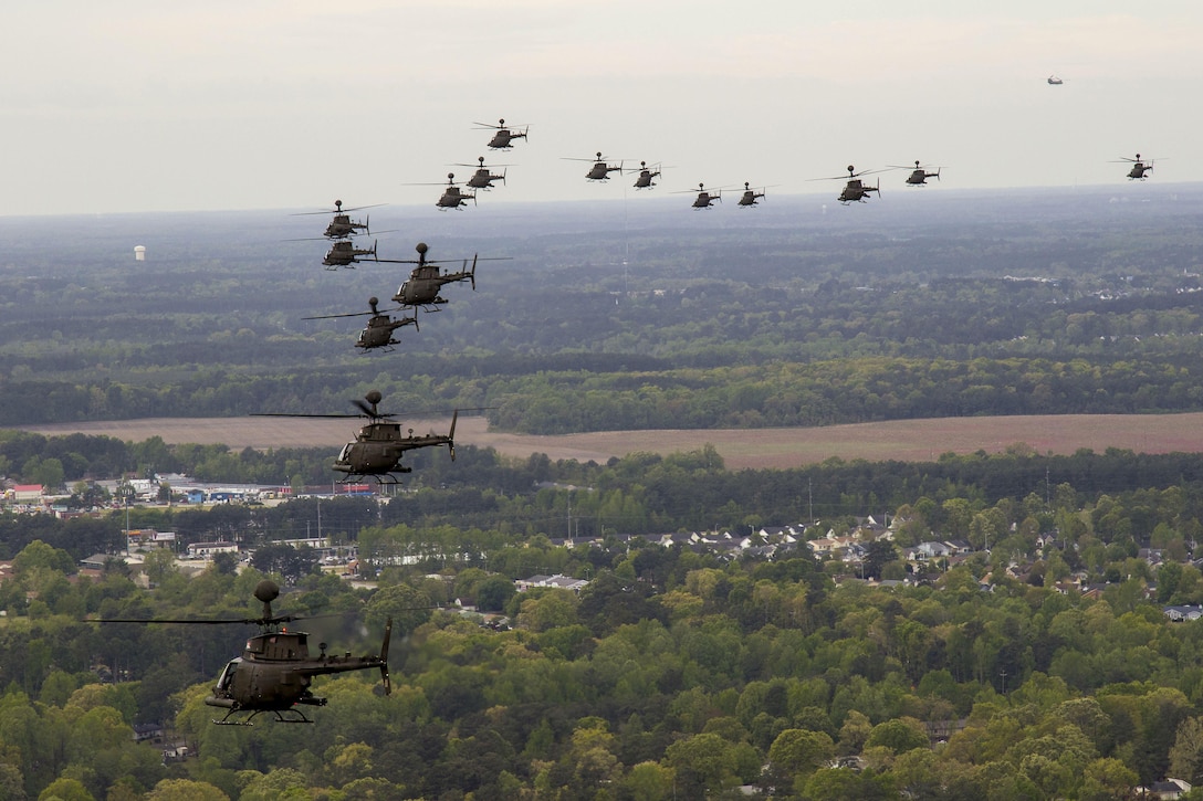 Thirty-two OH-58D Kiowa Warrior helicopters participate in a flyover above Fort Bragg, N.C., 2016, during the final stateside flight of the aircraft, April 15, 2016. Army photo by Sgt. Daniel Schroeder
