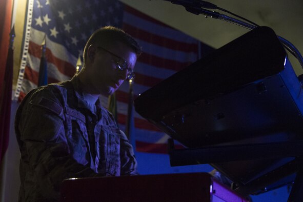 Airman 1st Class Sam Bachelder, a keyboard player with the U.S. Air Forces Central Command Band, Galaxy, plays during a performance at Hamid Karzai International Airport, Afghanistan, April 16, 2016. The band put on the performance for troops from more than 10 NATO member nations. (U.S. Army photo/Spc. Travis Terreo)