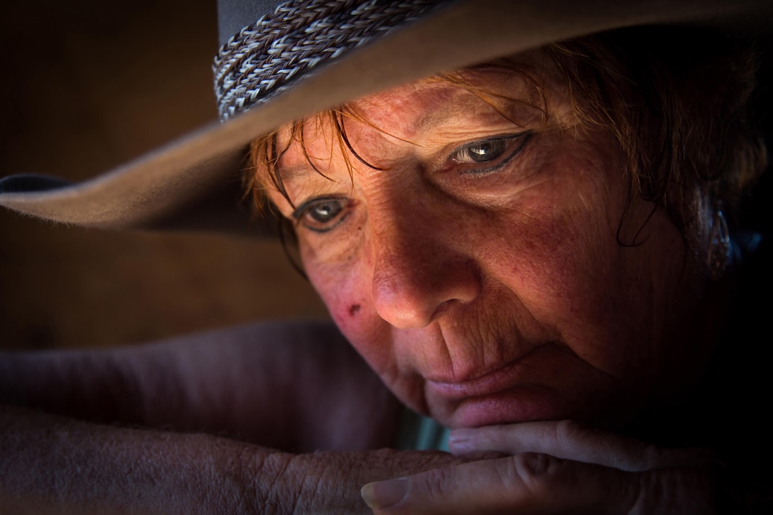Portrait Personality: Susan Peterson rests on a barn door in Norco, Calif., June 18, 2015. Peterson spent the morning playing with her horses and mule. The photo was taken during the 2015 Department of Defense Photography workshop held in Riverside, Calif. The workshop brought photographers and videographers from across the DoD together, while industry and military leaders mentored and developed them for a week. Army photo by Staff Sgt. Marcus Fichtl