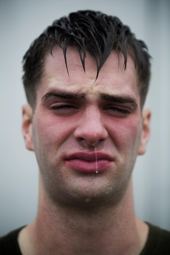 Portrait Personality: Marine Corps Pfc. Robert Wnetrzak poses for a photo after being sprayed in the face with oleoresin capsicum, or OC spray, and running through a confidence course at Marine Corps Air Station Futenma, Okinawa, March 6, 2015.  Marine Corps photo by Sgt. Matthew Callahan