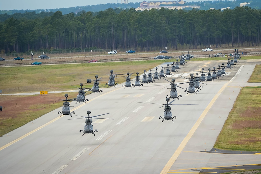 Thirty-two OH-58D Kiowa Warrior helicopters prepare to takeoff and participate in a flyover above Fort Bragg, N.C., 2016, during the final stateside flight of the aircraft, April 15, 2016. DoD photo by Kenneth Kassens