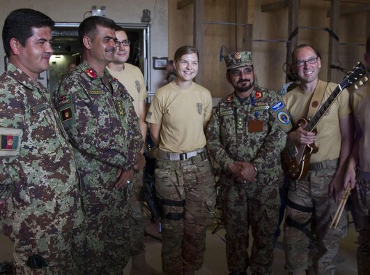 Members of the U.S. Air Forces Central Command Band, Galaxy, stand with Afghan Air Force service members after their performance April 17, 2016, at Hamid Karzai International Airport, Afghanistan. They gave members of the Train, Advise, Assist Command-Air and their Afghan counterparts an opportunity to get together in a purely social environment. (U.S. Army photo/Spc. Travis Terreo)