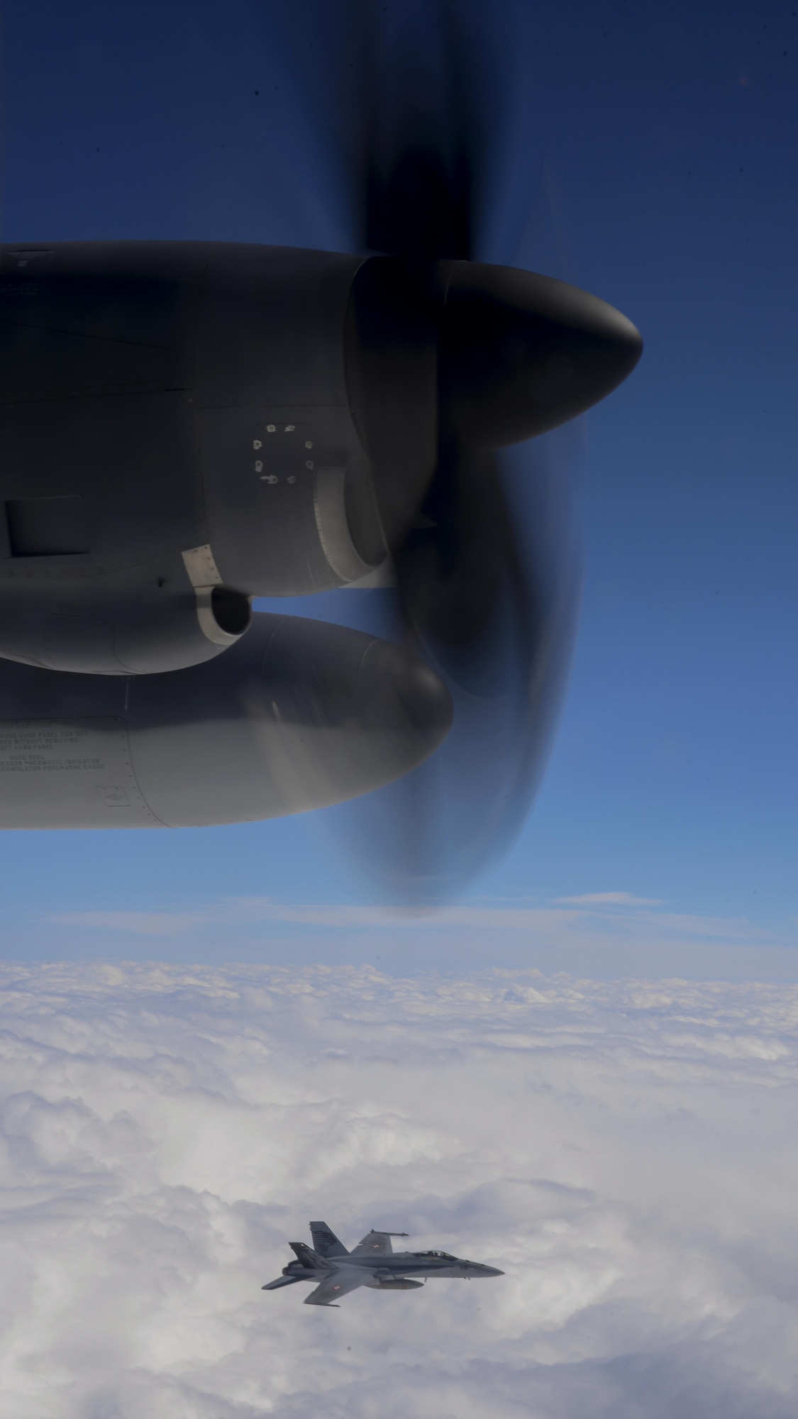 A U.S. Air Force MC-130J Commando II assigned to the 67th Special Operations Squadron participates in aerial intercept training with a Swiss Air Force F-18 Hornet during an exercise April 13, 2016. Performing joint training exercises strengthen ties with allies to ensure mission accomplishment. (U.S. Air Force photo by Senior Airman Victoria H. Taylor/Released)