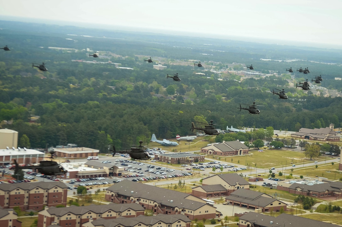 Thirty-two OH-58D Kiowa Warriors helicopters participate in a final flyover near the 82nd Airborne Divisions Museum at Fort Bragg, N.C., April 15, 2016. DoD photo by Kenneth Kassens