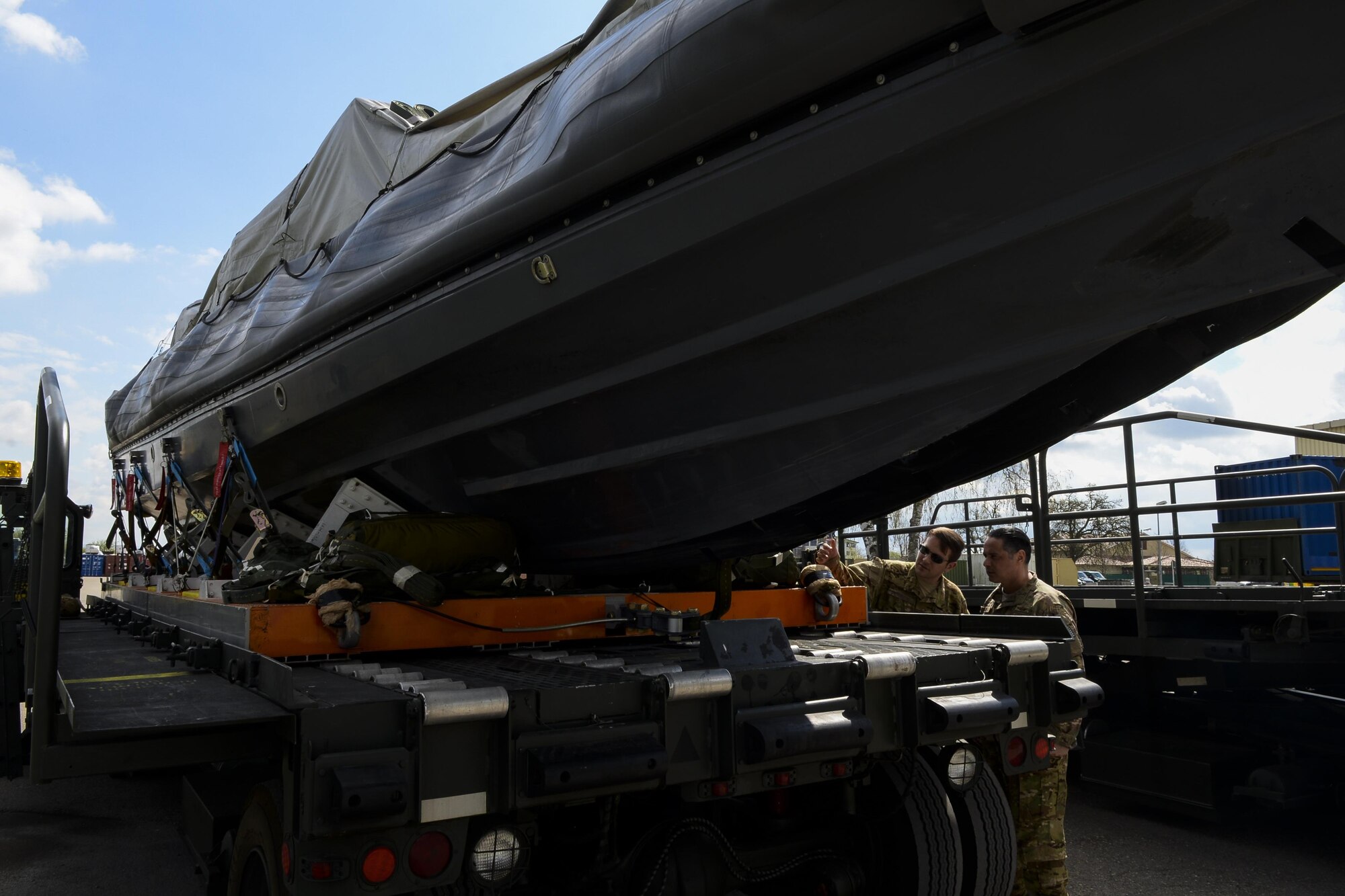 U.S. Air Force Master Sgt. Lino Gato and Senior Airman Nicholas Sternberg, both 67th Special Operations Squadron MC-130J Commando II loadmasters, inspect a Rigid Inflatable Boat before it is loaded onto an aircraft for a Maritime Craft Aerial Delivery System drop during an exercise April 14, 2016, at Stuttgart Air Base, Germany. Airborne Systems MCADS is the only airdrop system currently in service that is capable of delivering large Rigid Inflatable Boats. (U.S. Air Force photo by Senior Airman Victoria H. Taylor/Released)