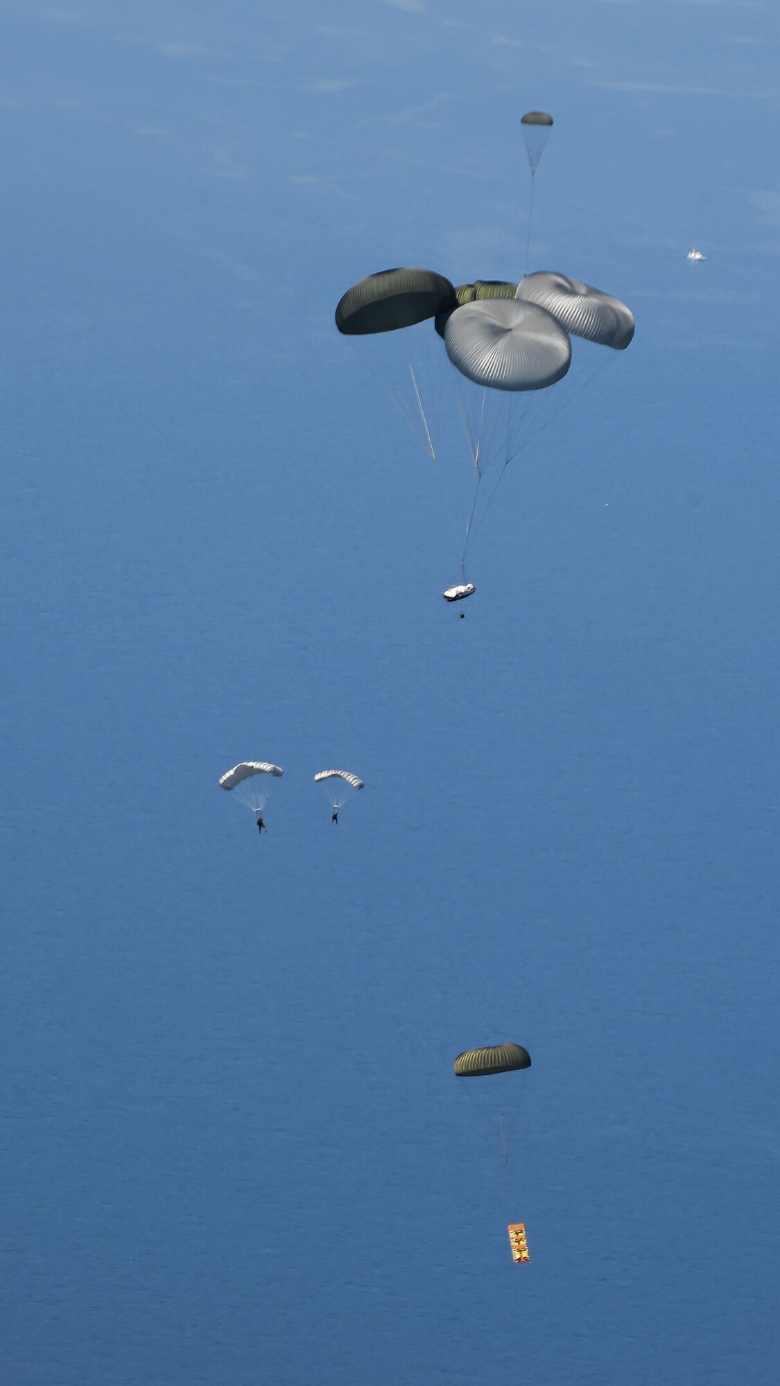 Members of the U.S. Navy Special Warfare Combatant-Craft unit perform high-altitude, low-opening parachute jumps into the Black Sea during an exercise April 16, 2016, off the coast of Bulgaria. Airmen from RAF Mildenhall, England, worked with the Naval unit to deploy a large Rigid Inflatable boat off the coast of Bulgaria while merging the capabilities of the U.S. Air Force and the U.S. Navy. (U.S. Air Force photo by Senior Airman Victoria H. Taylor/Released)