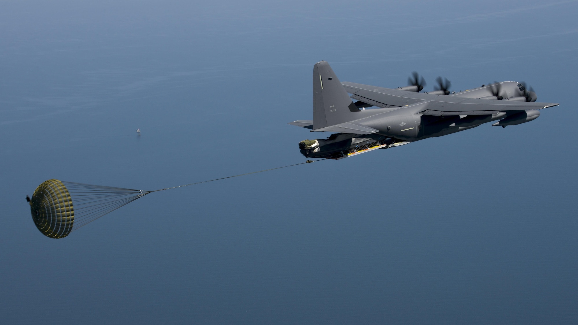 A U.S. Air Force MC-130J Commando II performs a Maritime Craft Aerial Delivery System drop during an exercise April 16, 2016, over the Black Sea. Airborne Systems MCADS is the only airdrop system currently in service that is capable of delivering large Rigid Inflatable Boats.(U.S. Air Force photo by Senior Airman Victoria H. Taylor/Released)