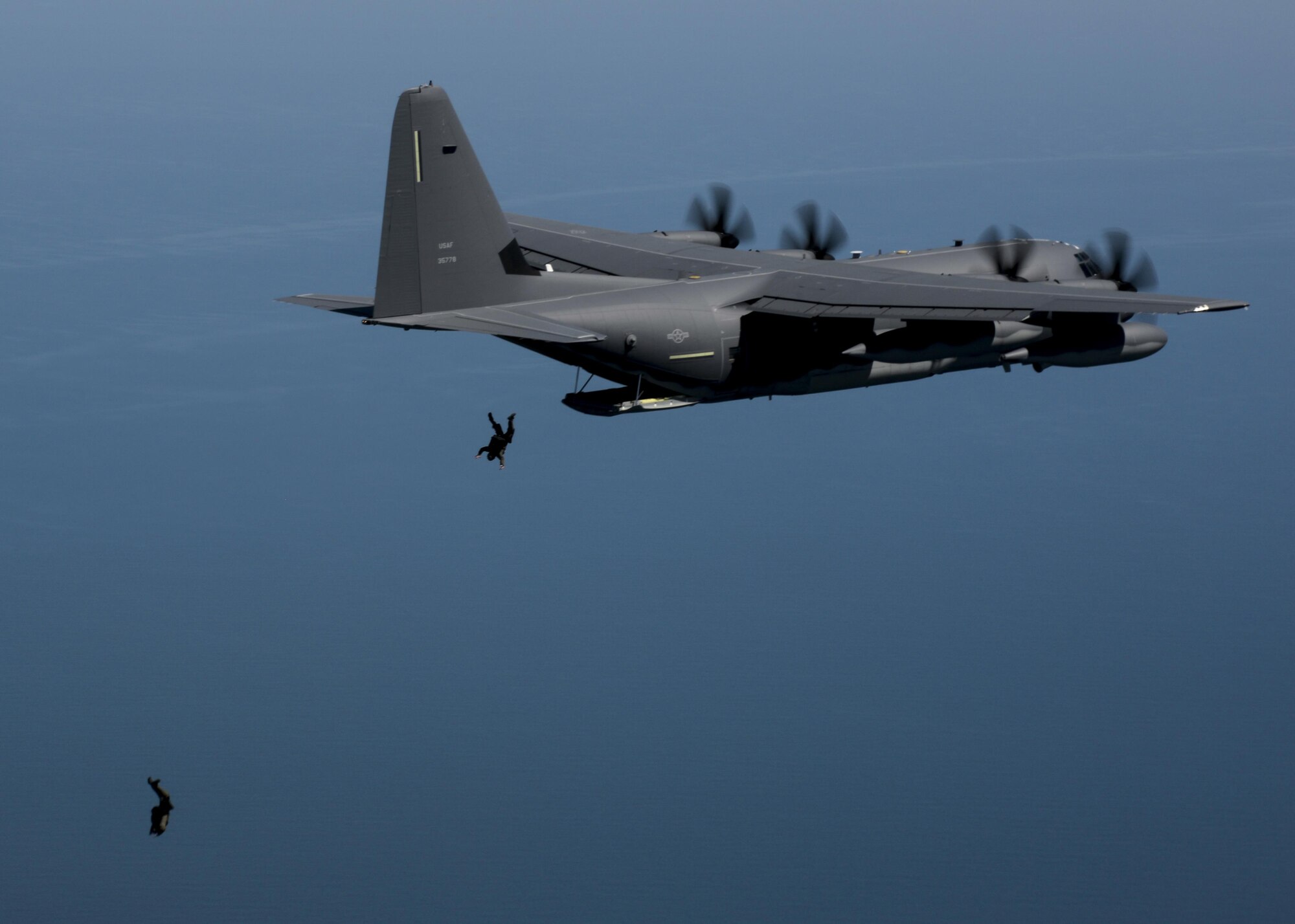 Members of the U.S. Navy Special Warfare Combatant-Craft unit perform high-altitude, low-opening parachute jumps from the back of a U.S. Air Force MC-130J Commando II during an exercise April 16, 2016, over the Black Sea. Airmen from RAF Mildenhall, England, worked with the Naval unit to deploy a large Rigid Inflatable boat off the coast of Bulgaria while merging the capabilities of the U.S. Air Force and the U.S. Navy. (U.S. Air Force photo by Senior Airman Victoria H. Taylor/Released)