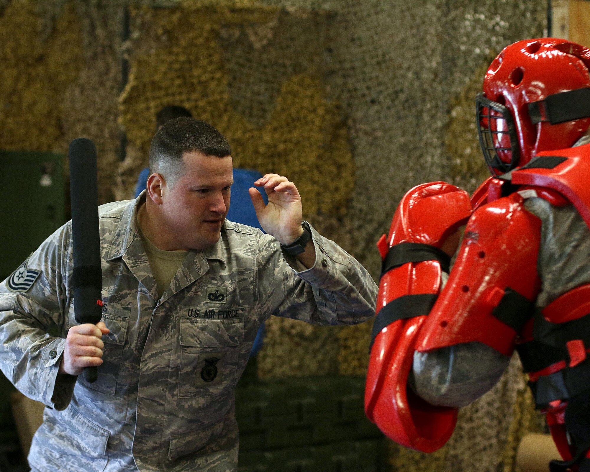 Tech. Sgt. Matthew B. Edds, 445th Security Forces Squadron, defends against attacker in a ‘Red Man’ suit (Senior Airman Alexander Stephens, 445th SFS), as a part of expandable baton certification training here April 2, 2015. The baton is a non-lethal defensive weapon used against actively non-compliant subjects. (U.S. Air Force photo /Tech. Sgt. Patrick O’Reilly)