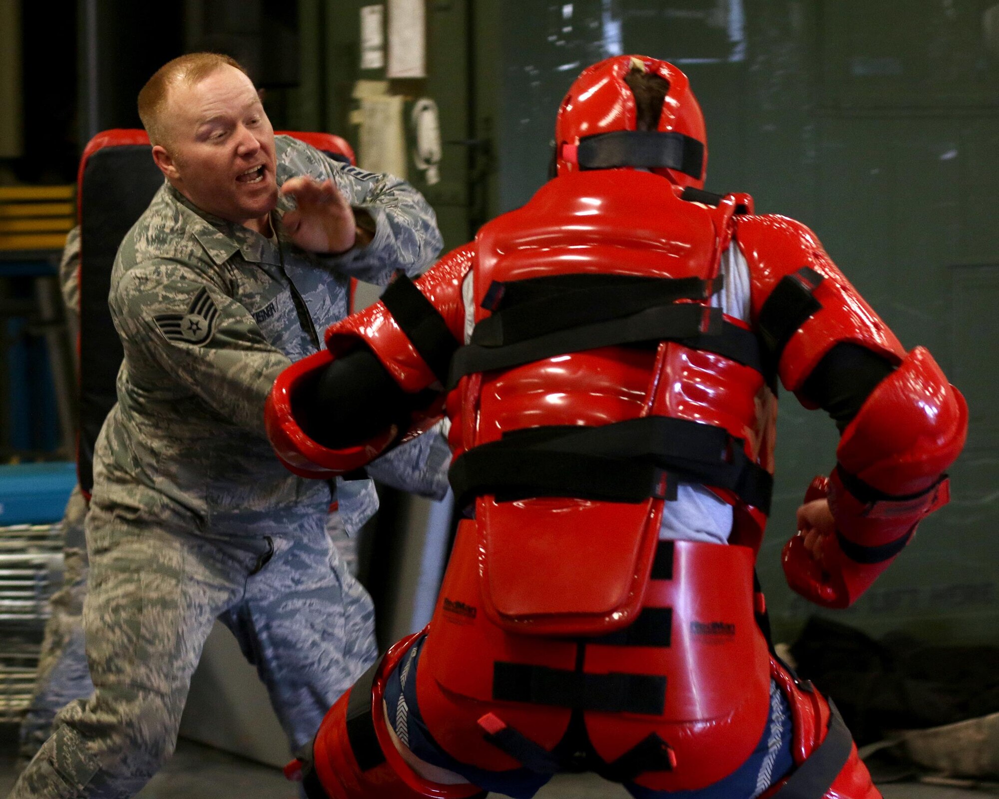 Staff Sgt. Timothy Kisner, 445th Security Forces Squadron, defends against attacker in a ‘Red Man’ suit (Staff Sgt. Jake McCorkle, 445th SFS), as a part of expandable baton certification training here April 2, 2015. The baton is a non-lethal defensive weapon used against actively non-compliant subjects. (U.S. Air Force photo /Tech. Sgt. Patrick O’Reilly)