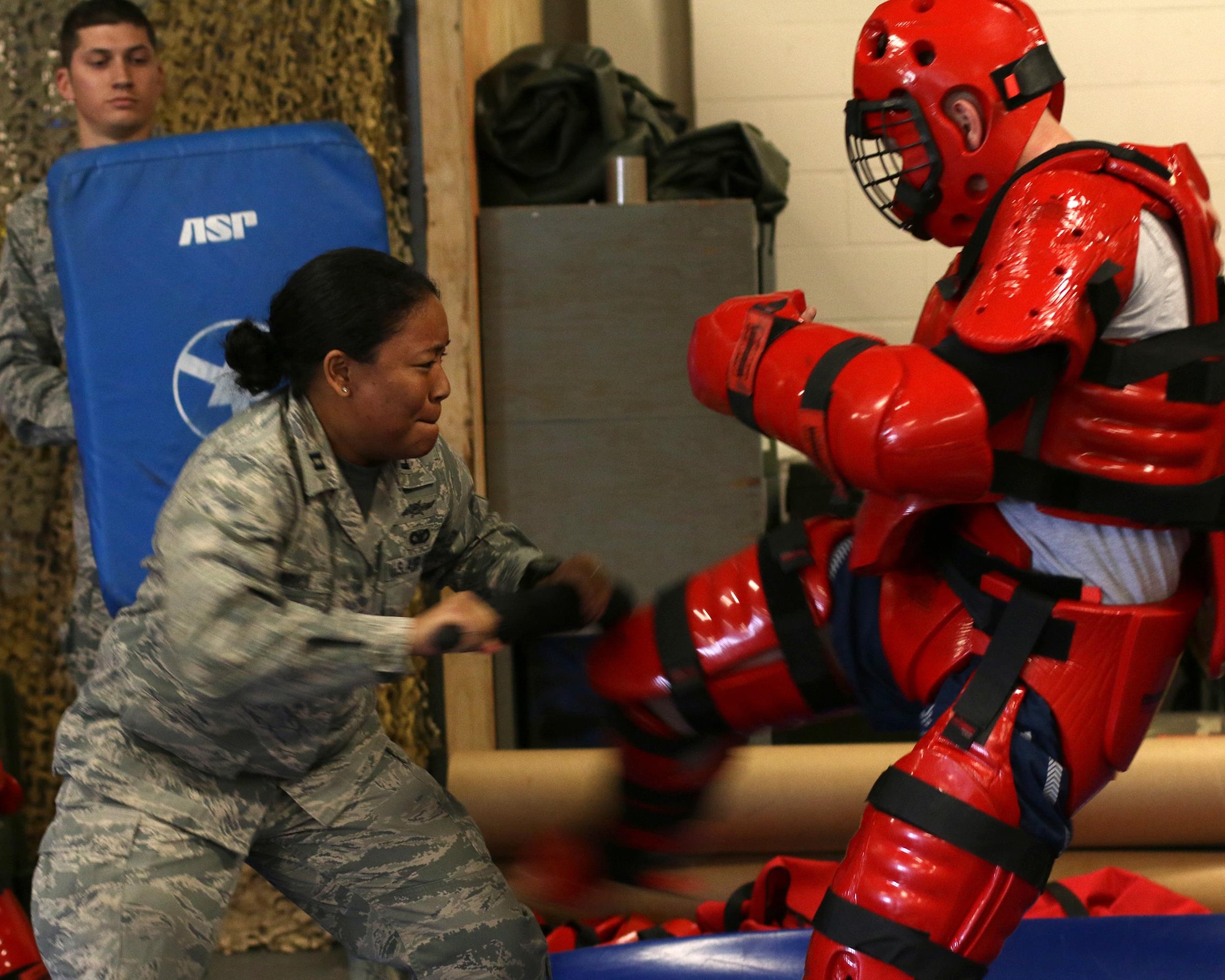 Capt. Jessica Wruck, 445th Security Forces Squadron, defends against attacker in a ‘Red Man’ suit (Staff Sgt. Jake McCorkle, 445th SFS), as a part of expandable baton certification training here April 2, 2015. The baton is a non-lethal defensive weapon used against actively non-compliant subjects. (U.S. Air Force photo /Tech. Sgt. Patrick O’Reilly)