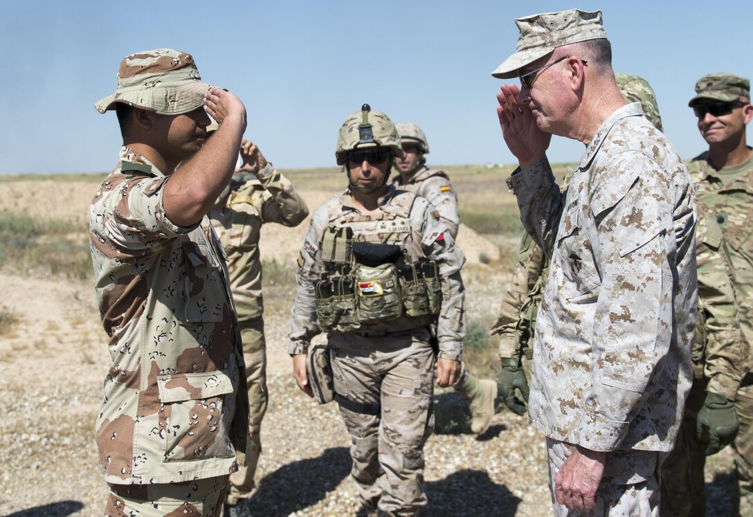 Marine Corps Gen. Joe Dunford, chairman of the Joint Chiefs of Staff, returns a salute from an Iraqi trainer at Besmaya Range Complex, Iraq, April  21, 2016. DoD photo by Navy Petty Officer 2nd Class Dominique A. Pineiro