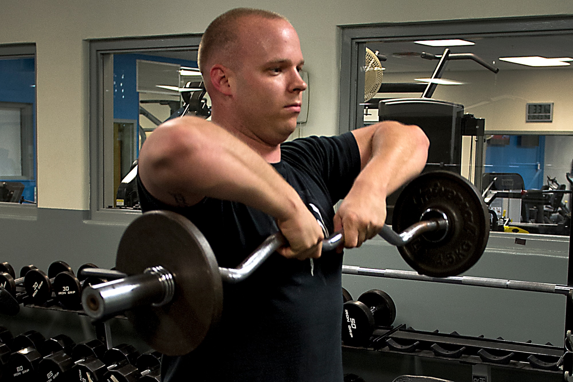 Marine Staff Sgt. Richard Kennedy, an admin chief assigned to Detachment 1, Communications Company, Combat Logistics Regiment 45, 4th Marine Logistics Group, lifts weights at the fitness center April 20, 2016 at Grissom Air Reserve Base, Ind. The fitness center will be transitioning to a 24-hour schedule for common access card holders this summer. (U.S. Air Force photo/Senior Airman Dakota Bergl)