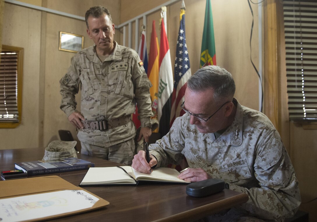 Marine Corps Gen. Joe Dunford, chairman of the Joint Chiefs of Staff, signs a guestbook for the Spanish commander at Besmaya Range Complex, Iraq, April  21, 2016. DoD photo by Navy Petty Officer 2nd Class Dominique A. Pineiro