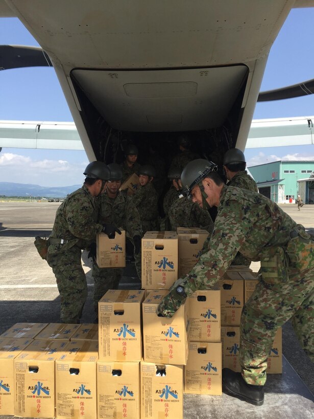 Japanese soldiers load humanitarian aid into a U.S. Marine Corps MV-22B Osprey aircraft at the Hakusui Sports Park on Kyushu Island, Japan, April 22, 2016. Marine Corps photo by Capt. Jennifer Giles