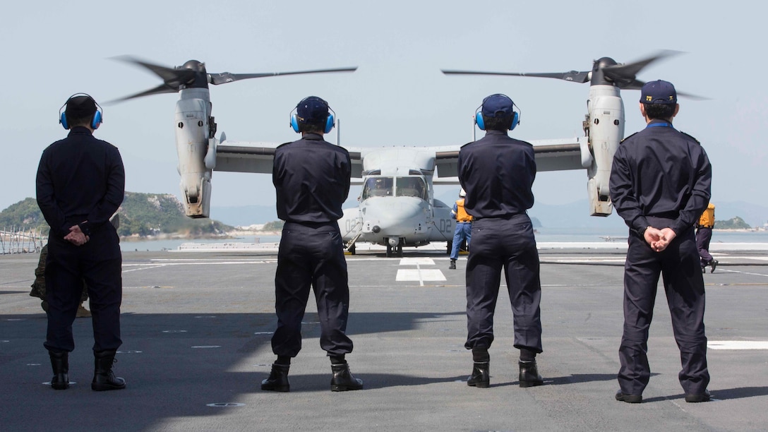 Japan Maritime Self-Defense Force officers watch as a U.S. Marine Corps MV-22B Osprey tiltrotor aircraft from Marine Medium Tiltrotor Squadron (VMM) 265 (Reinforced), 31st Marine Expeditionary Unit (MEU), refuels aboard the JS Hyuga (DDH 181), at sea, April 22, 2016. The Osprey received supplies from the Hyuga in support of the relief effort after a series of earthquakes struck the island of Kyushu. The 31st MEU is the only continually forward-deployed MEU and remains the Marine Corps' force-in-readiness in the Asia-Pacific region.